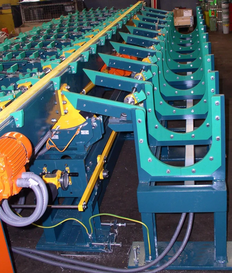 Green roller conveyor with V-shaped supports and drive motor for transporting round stock
