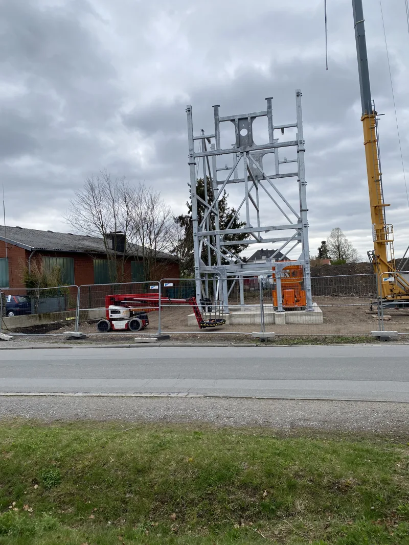 Galvanised steel frame of the E-Parktower during assembly, with a mobile crane alongside