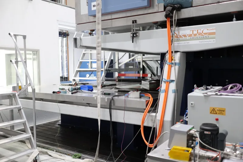 Test setup with specimens on the shaker table and the ENSYTEC nameplate on the substructure