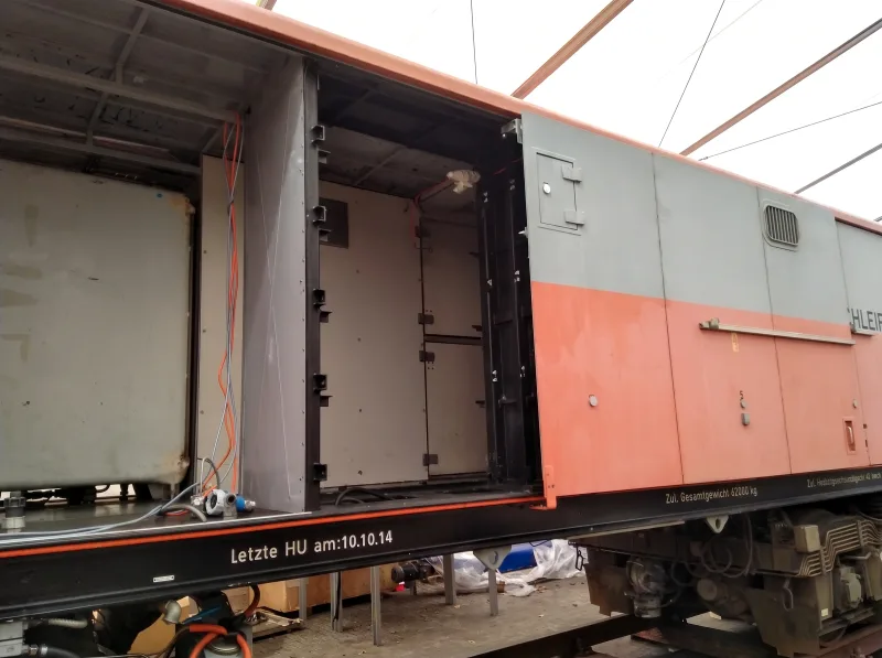 Opened battery compartment of the rail grinding vehicle after removal of the damaged rack