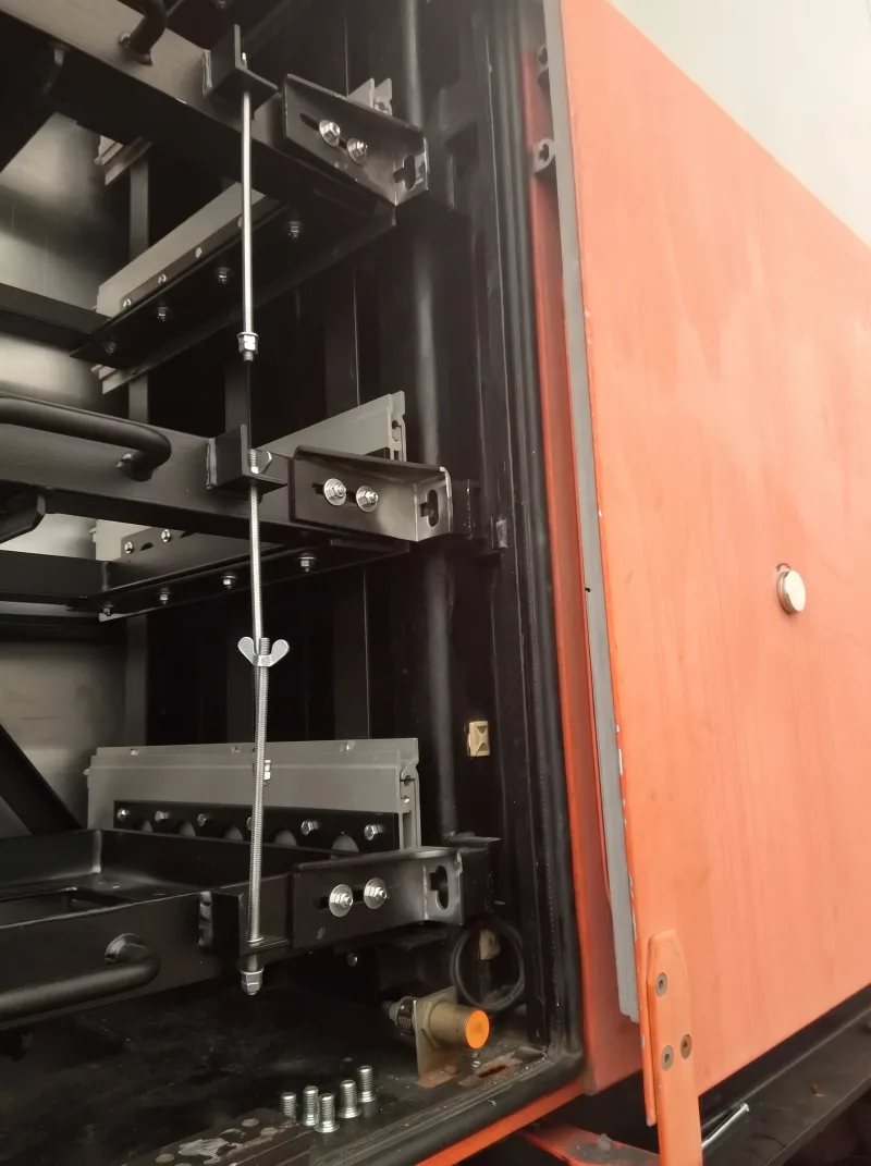 Detail of the new battery rack with pull-out rails and threaded rods securing the batteries
